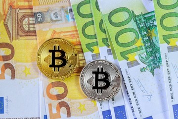 Golden Bitcoin and Silver Bitcoin on Euro Banknote background