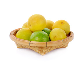 lime in bamboo basket isolated on white background