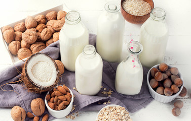 Alternative types of milks in glass bottles. Vegan non dairy milk