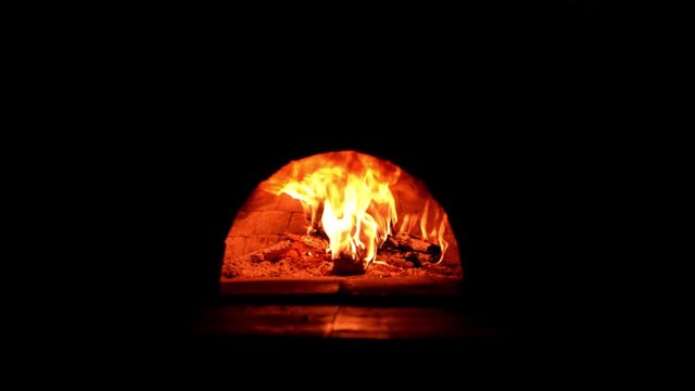 Fire burning in a forno (Pompeii) brick pizza oven. Fireplace