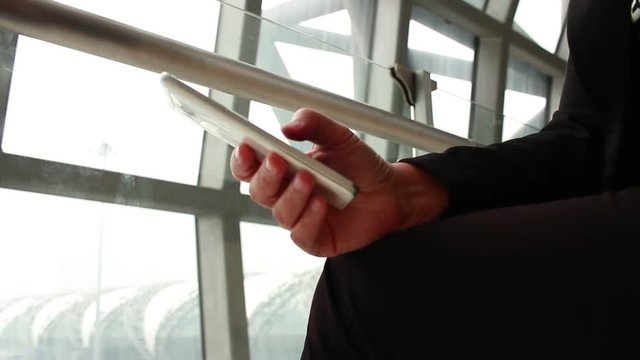 Businessman using cell phone sync app, Using Online checking flight table by network internet wireless development mobile smartphone for delayed flight in airport terminal, Internet concept.