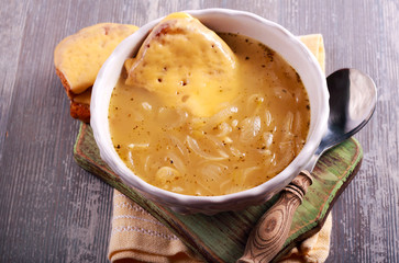 Onion soup in a bowl, served with grilled cheese