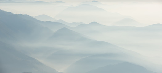 Morning landscape on hills and mountains with humidity in the air and pollution. Panorama from...
