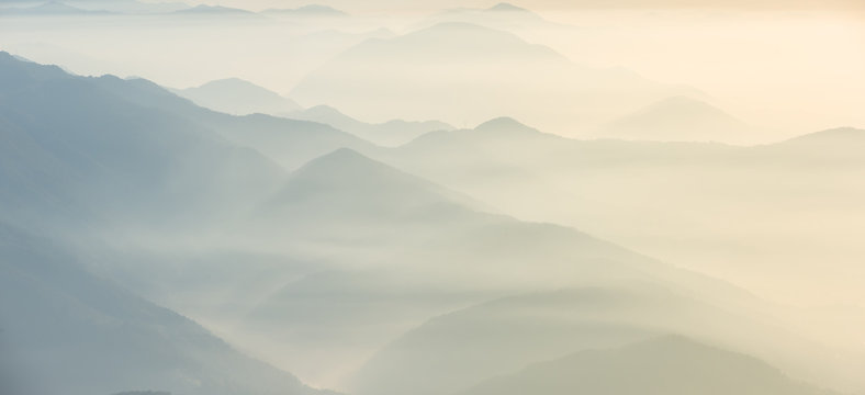 Morning landscape on hills and mountains with humidity in the air and pollution. Panorama from Linzone Mountain, Bergamo, Italy
