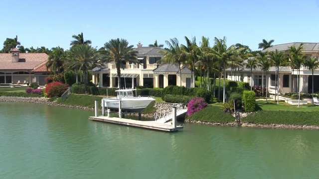Waterfront affluent rich wealthy luxury homes mansions gated community exclusive high-end real-estate retirement intracoastal waterway Port Royal Naples Florida.