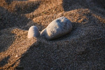 Fototapeta na wymiar Rock on sandy beach 