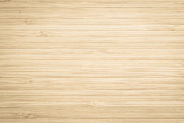 Wood texture old aged bamboo wooden kitchen cutting board grainy detail background in light gold...