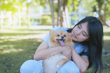 Cheerful woman playing with her dog at park