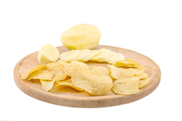 Cutting board with raw potato and potato chips isolated on white background.