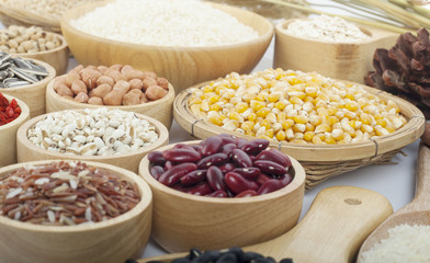 Cereal grains , seeds, beans on wooden background