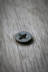 Nail on old wooden background