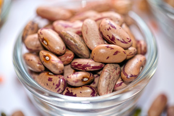 A close-up view of vibrant red kidney beans (Rajma) in a glass bowl, showcasing their speckled texture and rich color. These protein-packed legumes are a staple in Indian, Mexican, and global cuisines