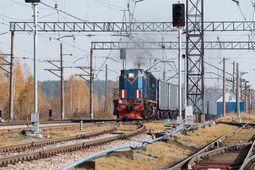 Freight train locomotive carrying with cargo on daylight
