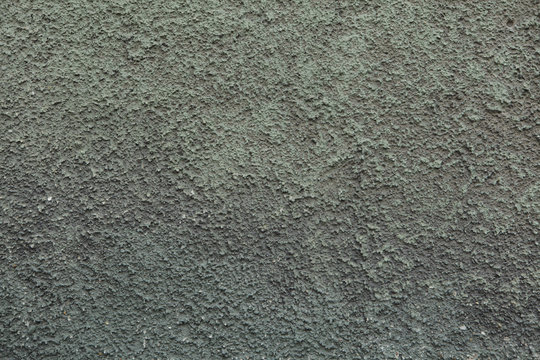 Green painted dirty stucco wall. Background texture