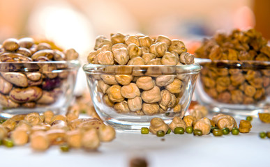 Close-up of Kabuli Chana (white chickpeas) in a glass bowl, showcasing their round shape and smooth beige texture. A staple in Mediterranean, Indian, and Middle Eastern cuisines, these protein-packed