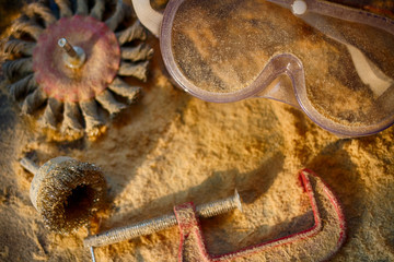 Fototapeta premium The workflow of a carpenter. The mess on the workbench. Protection of the eyes. Creative manual work.