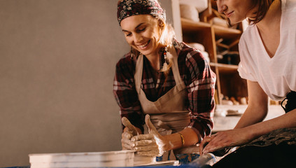 Female potter working on potters wheel