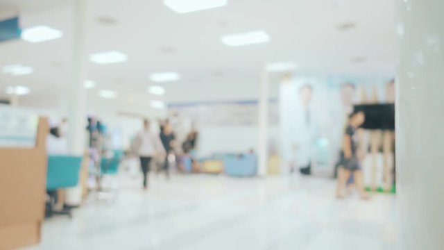 Blurred image with people walking in the hallway of hospital