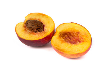 Half of ripe peach on the white background