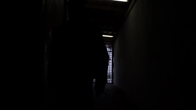 Prison officer walking in corridor in russian penitentiary colony, jail, prison at winter glidecam