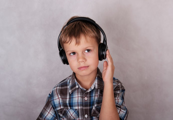 European boy listening to music on headphones