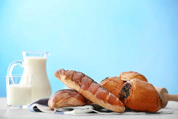 Tasty pastries with poppy seeds on table