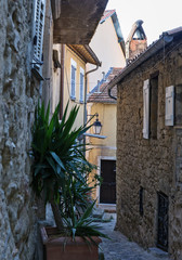 Narrow street with flowers in the old town Coaraze in France