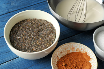 Ingredients for chia seed pudding on wooden background
