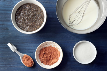 Ingredients for chia seed pudding on wooden background