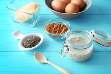 Composition with chia seed pudding on color wooden background