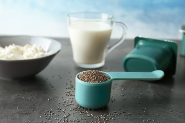Measuring scoop with chia seeds on table