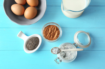 Composition with chia seed pudding on color wooden background