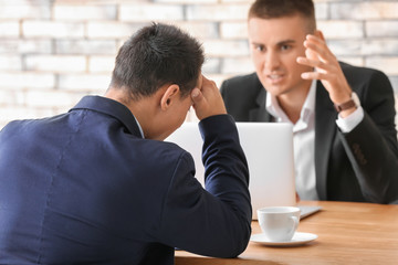 Human resources manager interviewing man at table