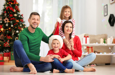 Happy family in room decorated for Christmas