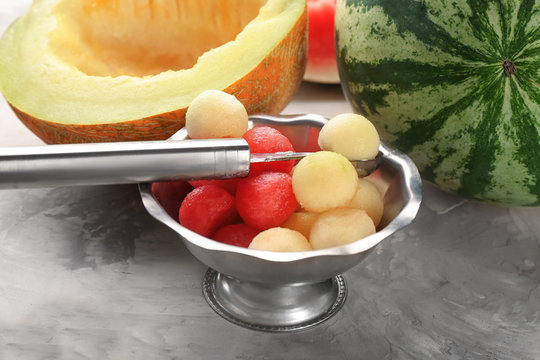 Metal bowl with melon and watermelon balls on table
