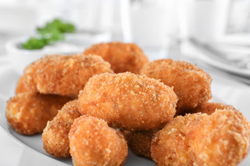 Delicious salmon croquettes on plate, closeup