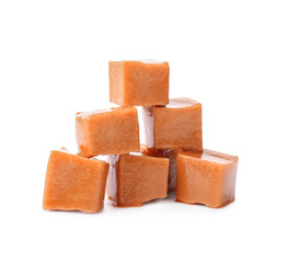 Sweet caramel candies on white background