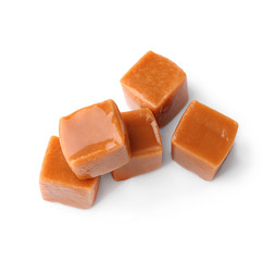 Sweet caramel candies on white background