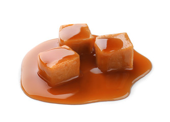 Sweet candies with caramel sauce on white background
