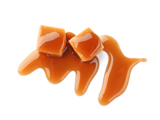 Sweet candies with caramel sauce on white background