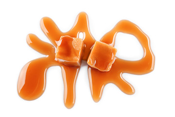 Sweet candies with caramel sauce on white background