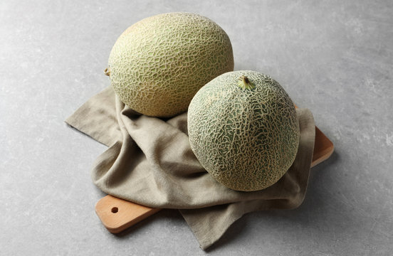 Ripe melons on grey background