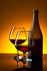 Two glasses and bottle of brandy.