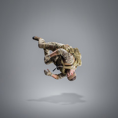 USA Army soldier with gun (motion effect).  Shot in studio on gray background. Action concept