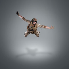 Obraz na płótnie Canvas USA Army soldier with gun (motion effect). Shot in studio on gray background. Action concept
