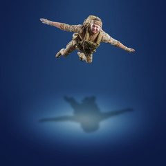 USA Army soldier with rifle (motion effect).  Shot in studio on blue background. Action concept