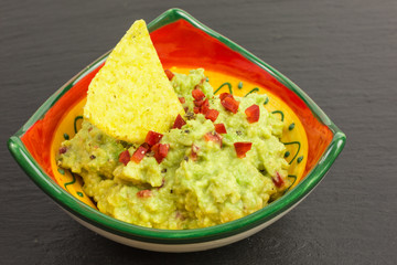 fresh homemade guacamole with diced chili and tortilla chips