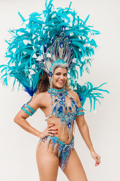 Beautiful and cheerful brazilian samba dancer wearing blue traditional costume