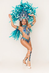 Gorgeous and cheerful brazilian samba dancer wearing traditional costume and performing