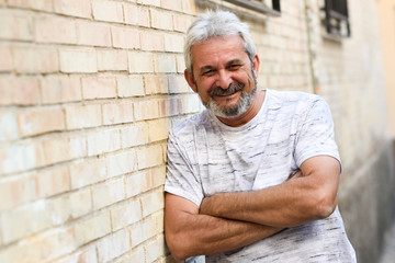 Mature man smiling looking at camera in urban background